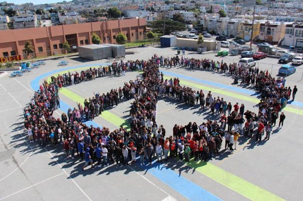Students forming a peace sign outside Denman Middle School