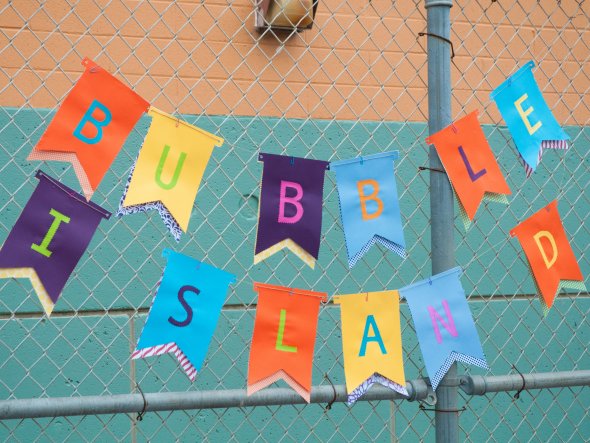 Colorful sign for Bubble Island at an outdoor school festival