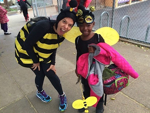 Parent and girl dressed up as bumblebees at a school Halloween event