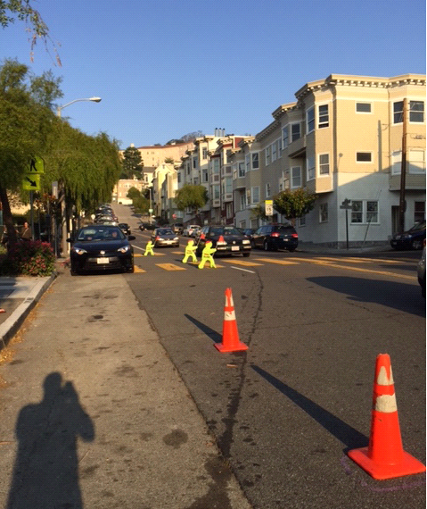 photo of traffic cones blocking lane of road near sidewalk
